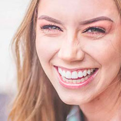 Smiling client testimonial portrait, woman with long hair