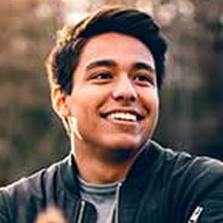 Smiling client testimonial portrait, young man outdoors